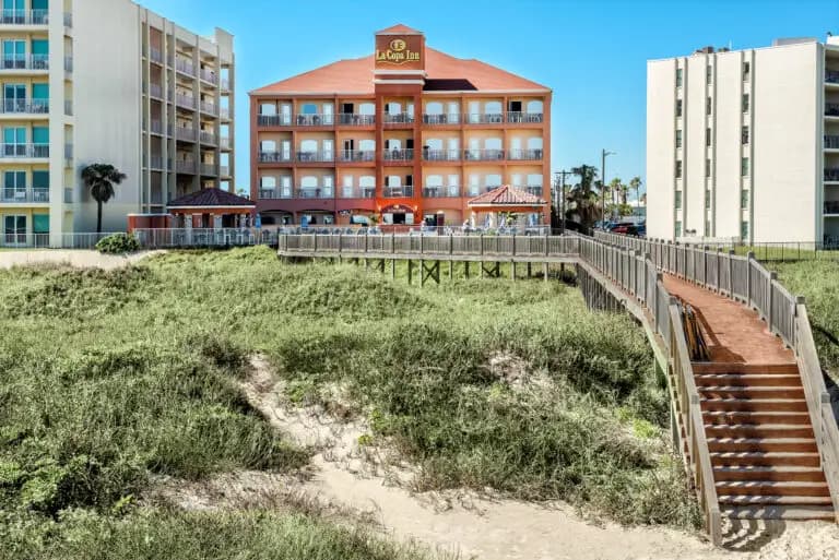 The boardwalk over the dunes, with the hotel behind it