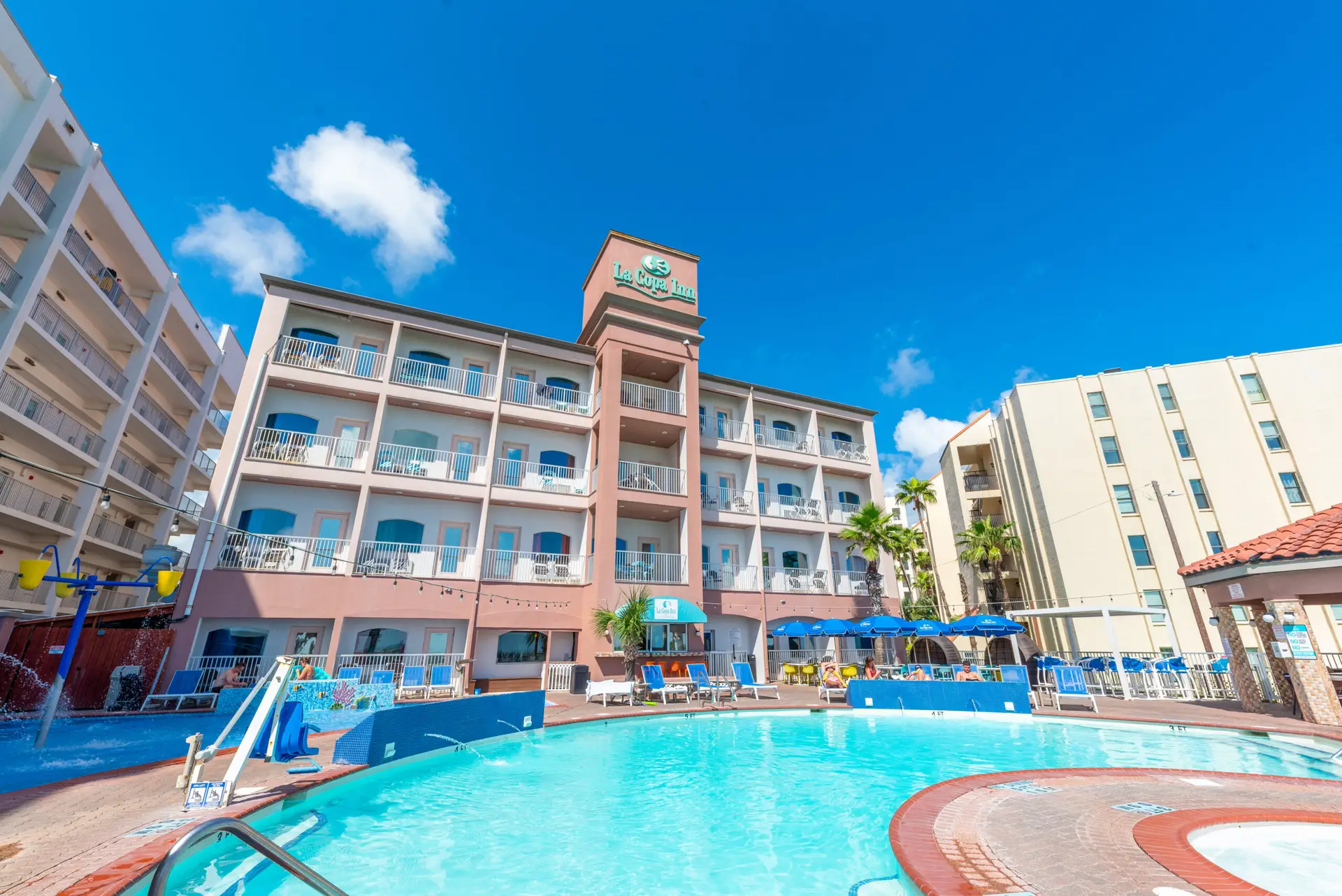 The hotel pool with the building behind it