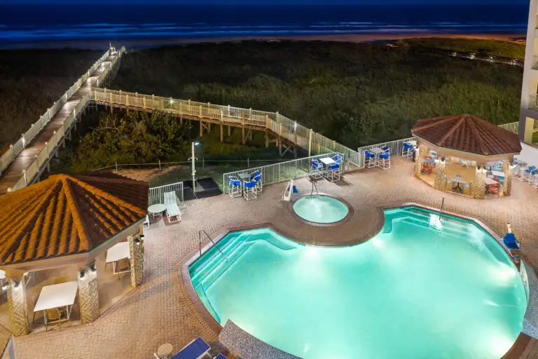 The pool and cabanas lit up at night